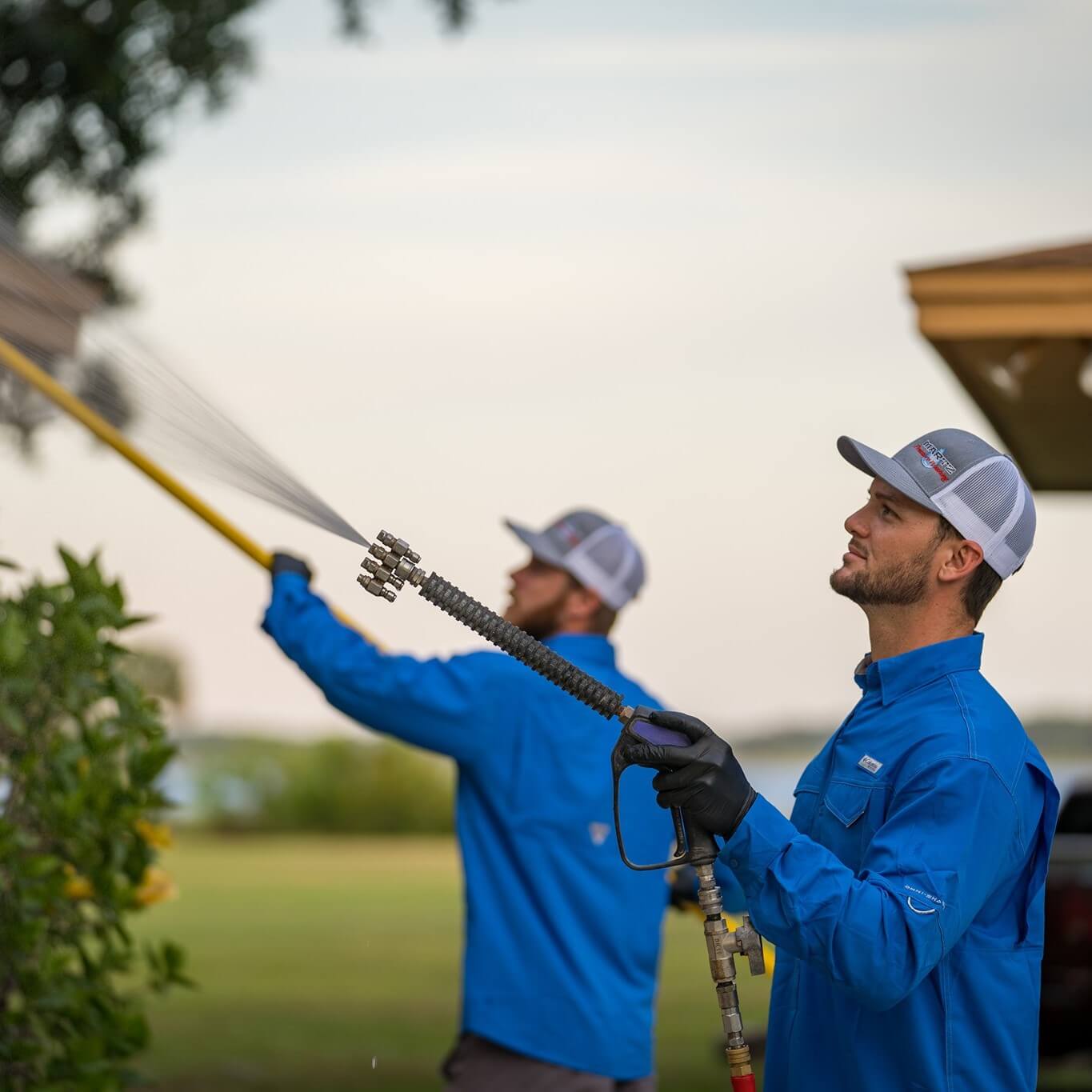 guy in blue uniform soft washing